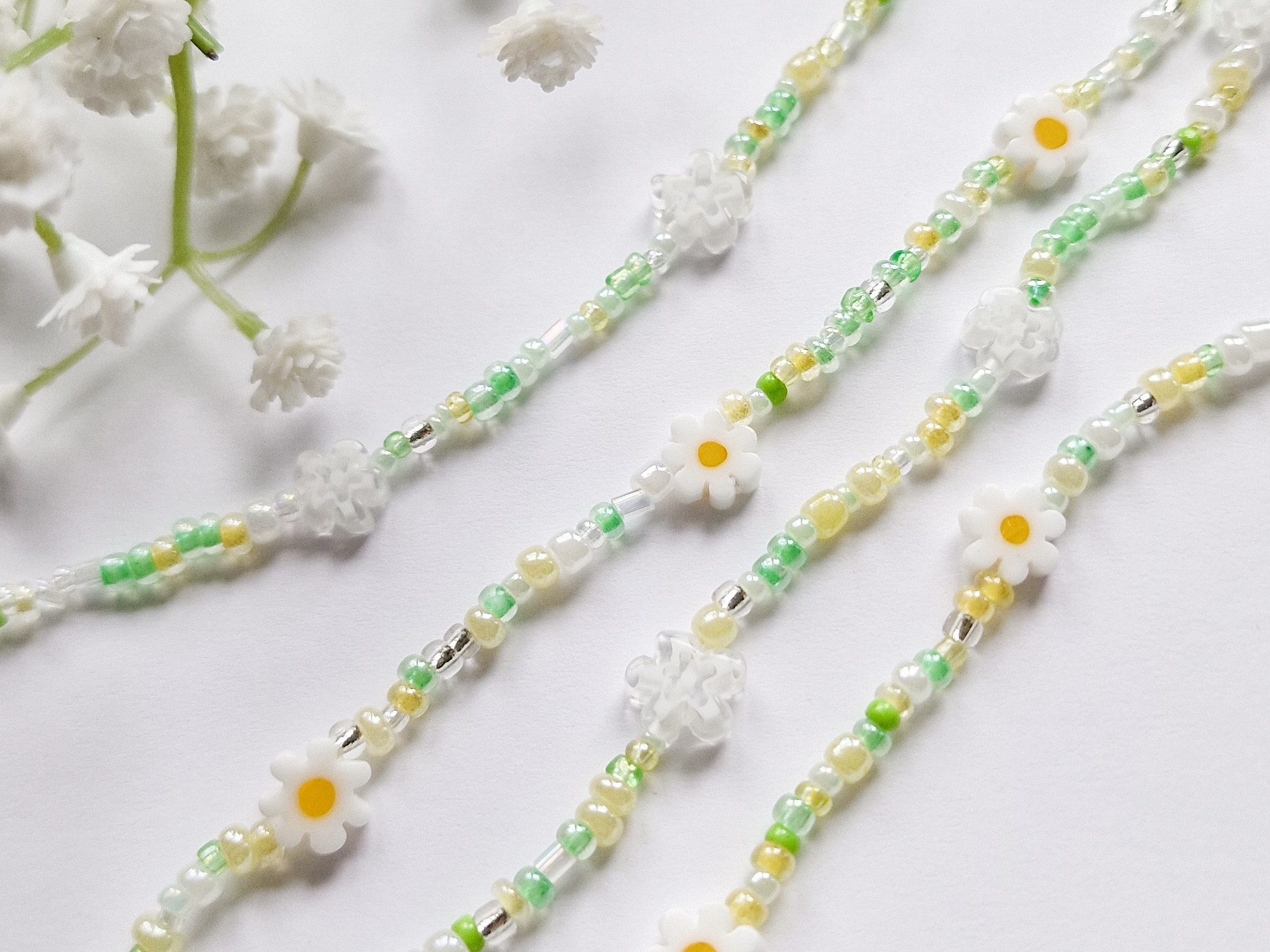 Perlesmykke i grønt med blomsterperler.